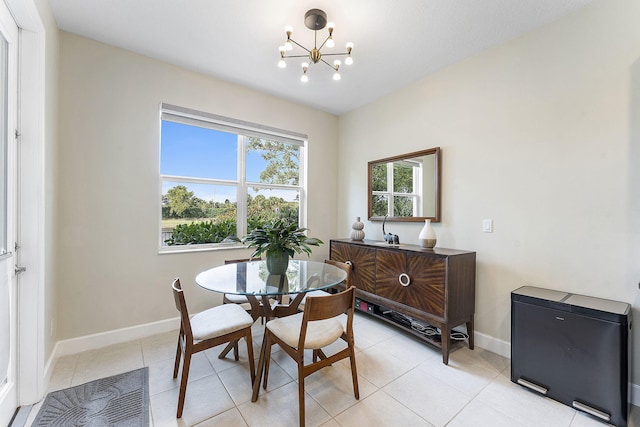 dining room with light tile patterned floors and a notable chandelier