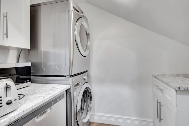 laundry room with stacked washer / drying machine