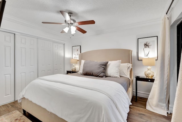 bedroom featuring a textured ceiling, ceiling fan, ornamental molding, and hardwood / wood-style floors