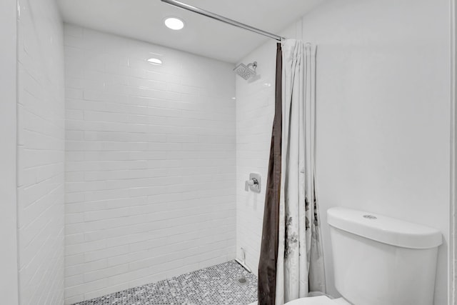 bathroom featuring toilet and a shower with shower curtain