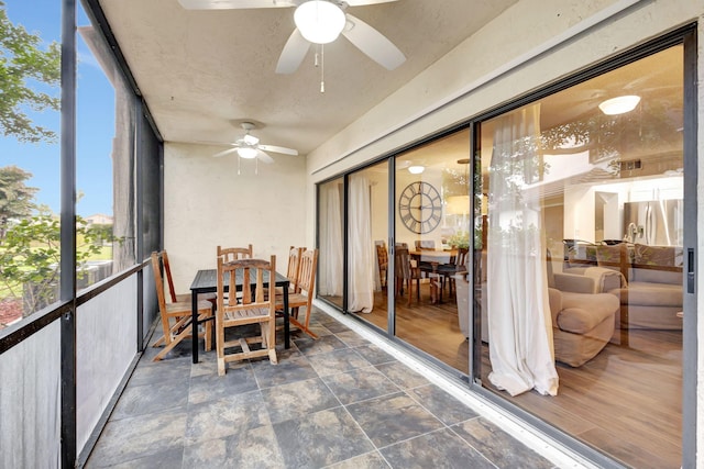 sunroom featuring ceiling fan