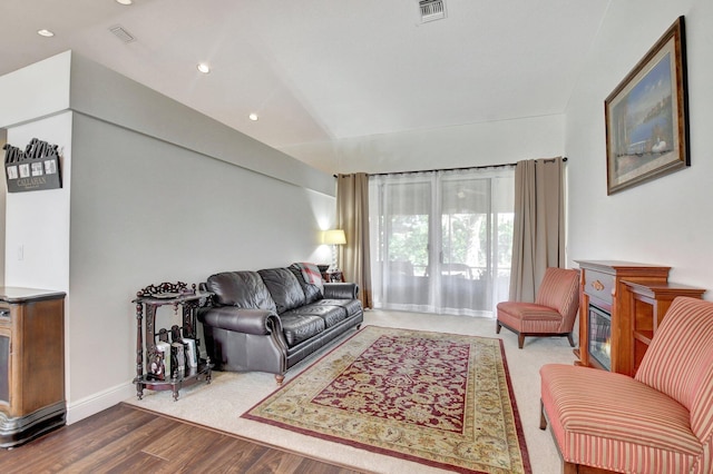 living room featuring hardwood / wood-style floors and vaulted ceiling