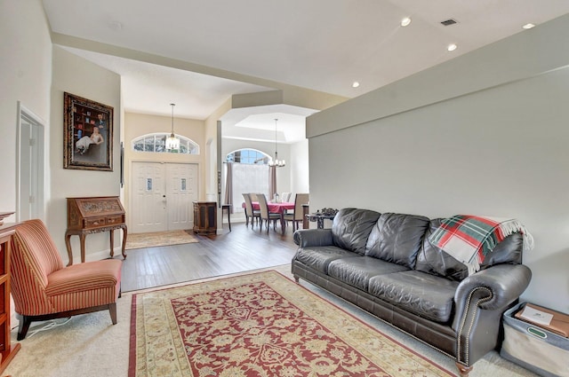 living room featuring an inviting chandelier and wood-type flooring