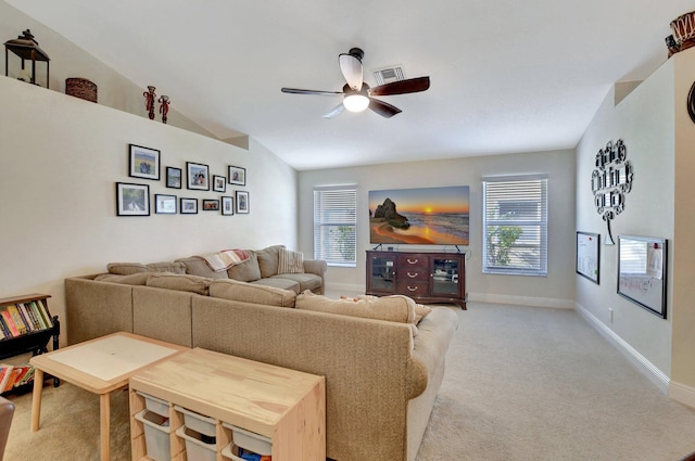 carpeted living room with lofted ceiling and ceiling fan