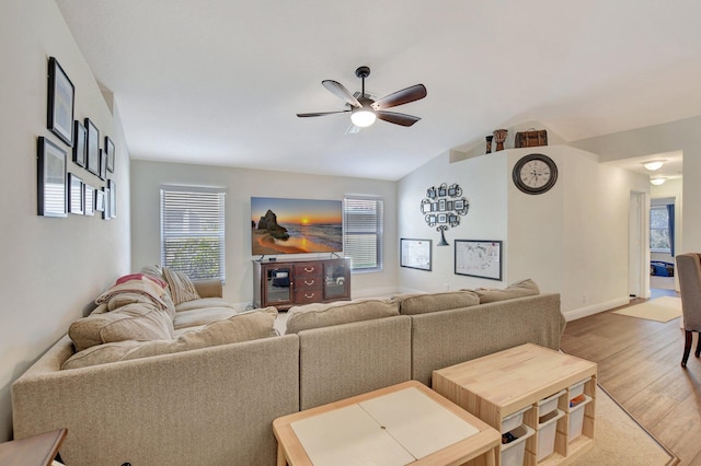 living room with hardwood / wood-style flooring, lofted ceiling, and ceiling fan