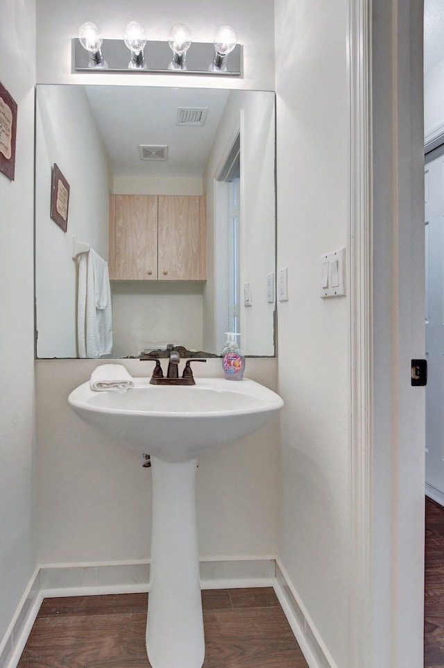 bathroom with hardwood / wood-style flooring and sink