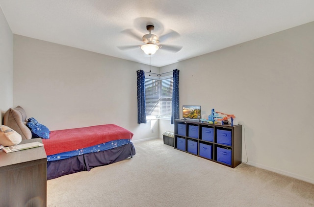 bedroom featuring ceiling fan and light colored carpet