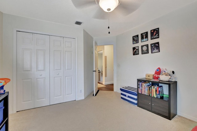 rec room with ceiling fan and carpet