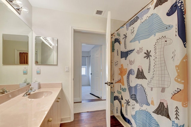 bathroom with vanity, hardwood / wood-style flooring, and a shower with shower curtain