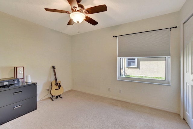 interior space with light colored carpet and ceiling fan