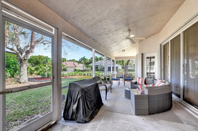 sunroom featuring ceiling fan