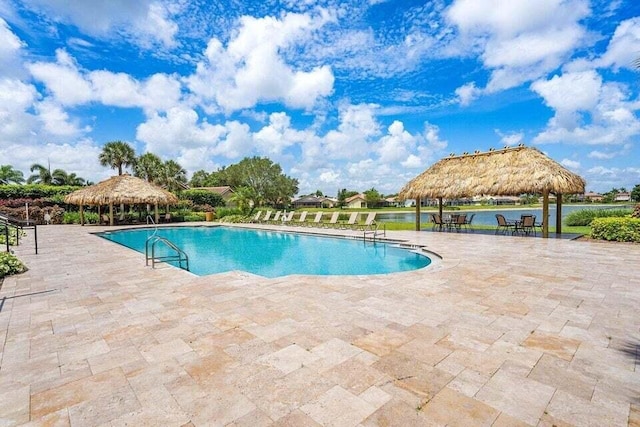 view of pool with a gazebo, a water view, and a patio