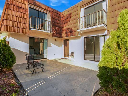 rear view of property with a patio area and a balcony