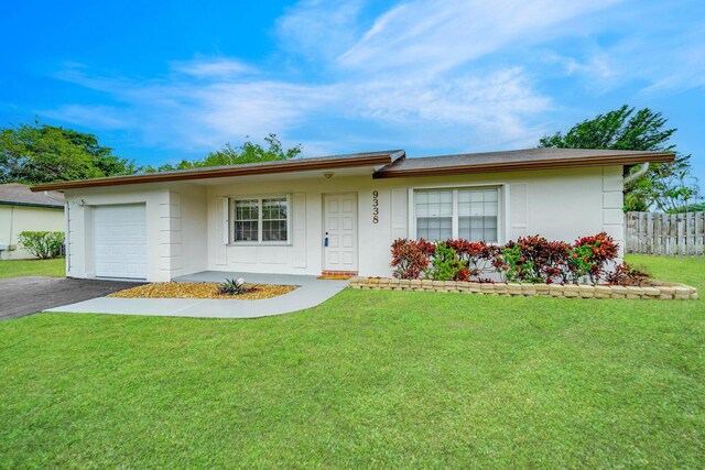 ranch-style house with a garage and a front yard