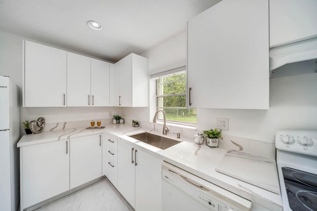 kitchen featuring sink, light stone counters, white cabinets, and white appliances