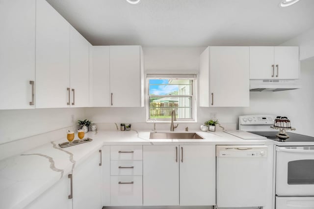 kitchen with white cabinetry, sink, white appliances, and light stone countertops