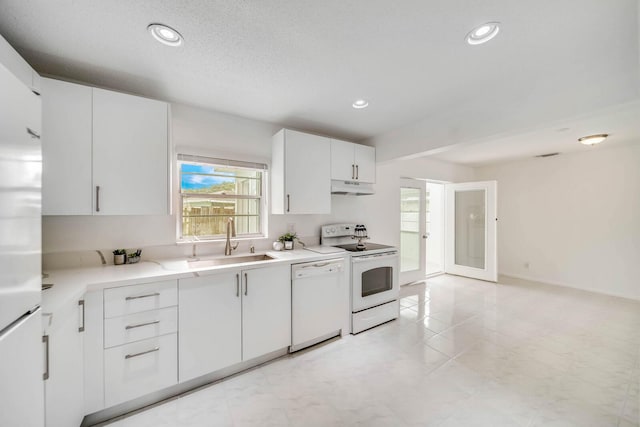 kitchen with white cabinetry, sink, a textured ceiling, and white appliances