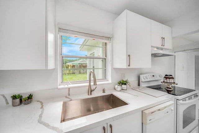 kitchen featuring white cabinetry, sink, and white appliances