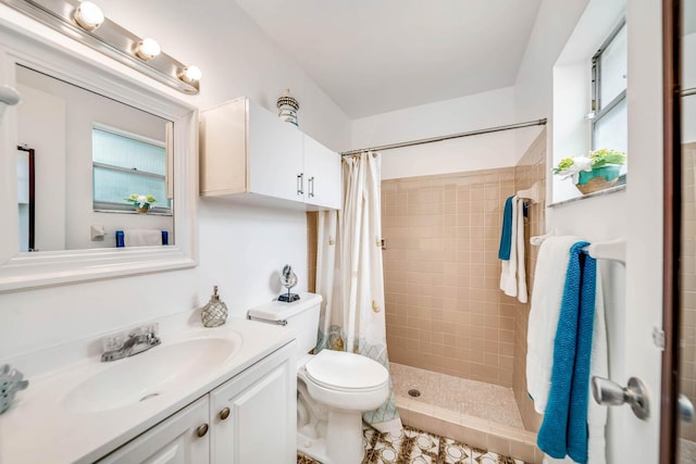 bathroom with a shower with curtain, vanity, and toilet