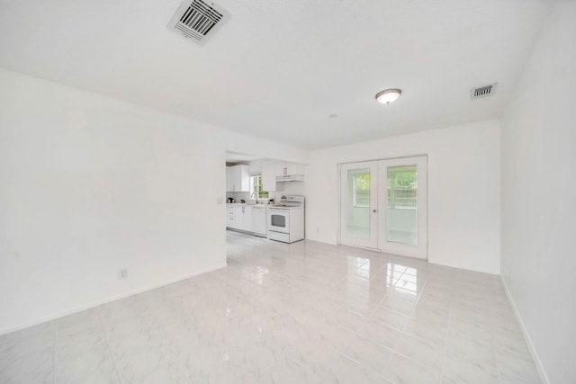 unfurnished living room with french doors and sink