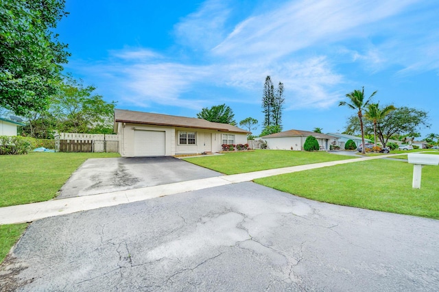 single story home featuring a front yard and a garage