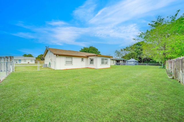 rear view of property with a yard