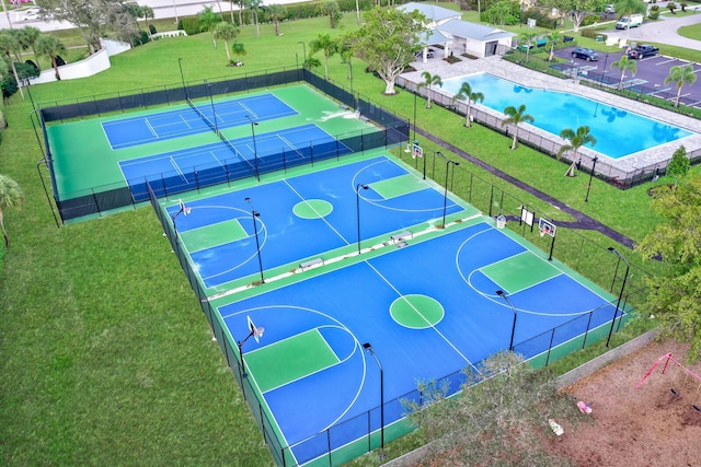 view of sport court with a yard and tennis court