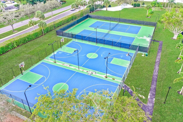 view of basketball court with a yard and tennis court