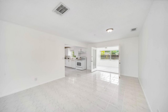 unfurnished living room with sink