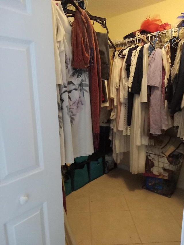 walk in closet featuring tile patterned flooring