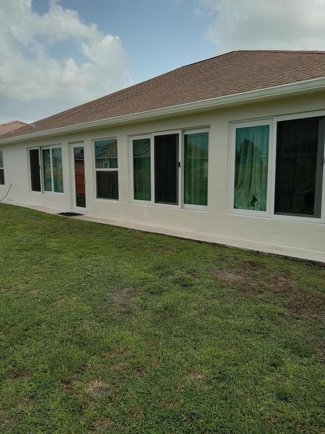 rear view of house with a yard