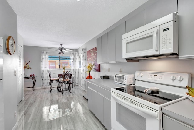 kitchen with gray cabinetry, white appliances, ceiling fan, a textured ceiling, and light wood-type flooring