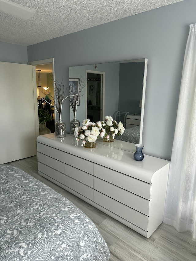 bathroom featuring hardwood / wood-style floors and a textured ceiling