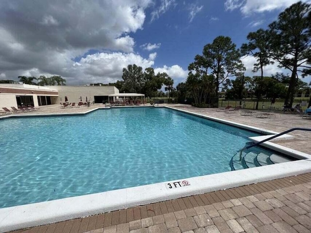 view of swimming pool featuring a patio area