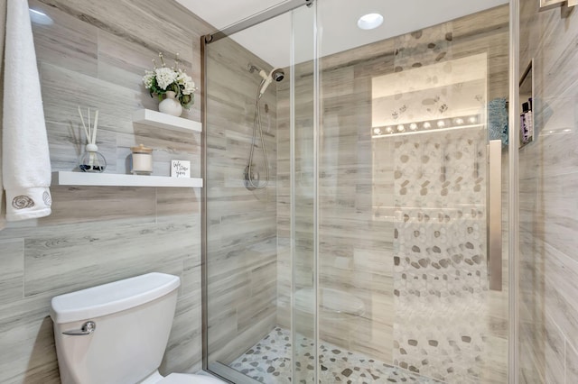 bathroom featuring toilet and walk in shower