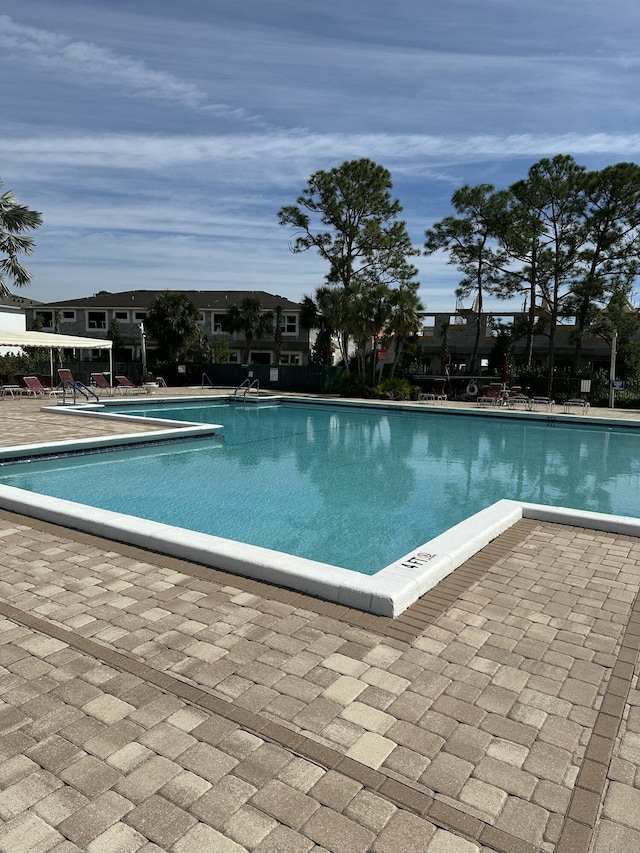 view of swimming pool with a patio