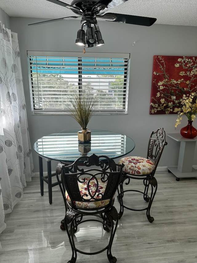 dining room featuring ceiling fan and a textured ceiling