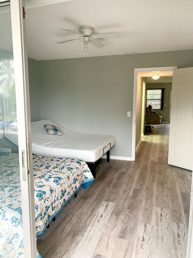 bedroom featuring ceiling fan and hardwood / wood-style floors