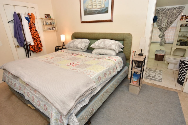 bedroom featuring tile patterned floors and a closet