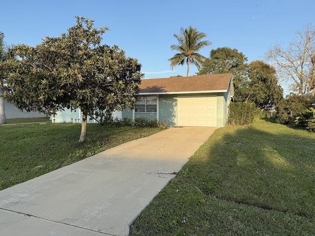 view of front of house featuring a garage and a front lawn