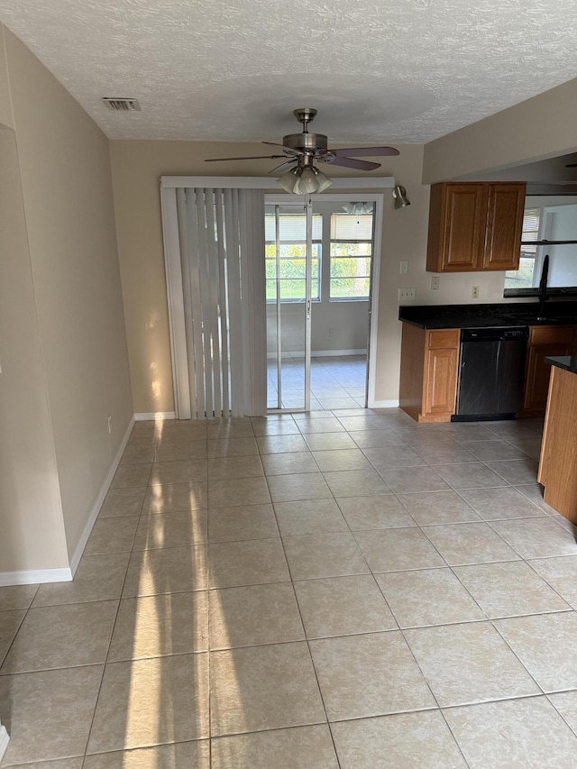 kitchen featuring ceiling fan, a textured ceiling, light tile patterned floors, and dishwasher