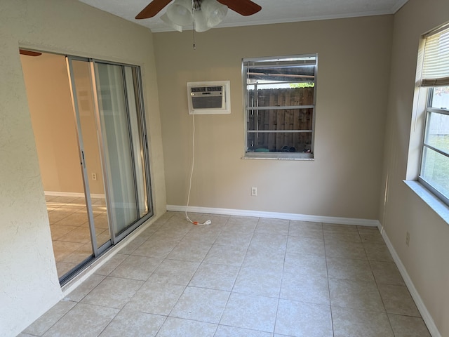 unfurnished room featuring a wall unit AC, ceiling fan, light tile patterned floors, and crown molding