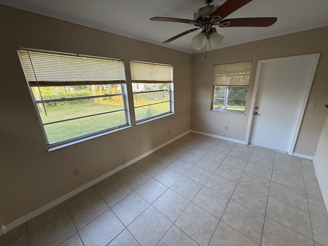 unfurnished room featuring ceiling fan and light tile patterned flooring