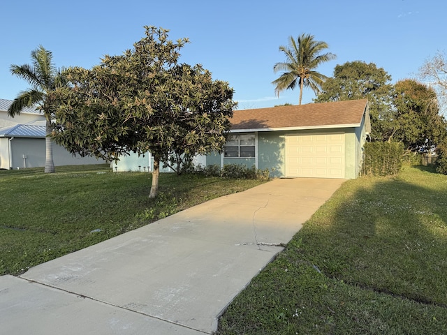 view of front of home featuring a garage and a front lawn