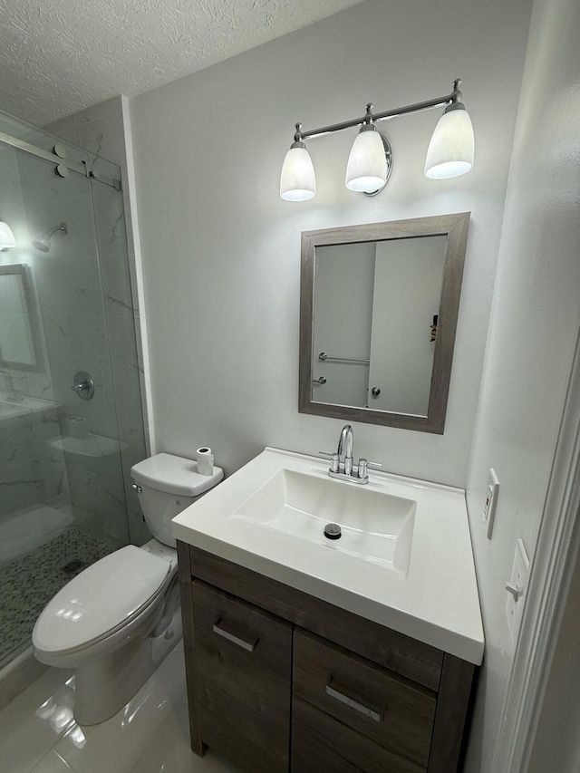 bathroom with a textured ceiling, toilet, vanity, and walk in shower