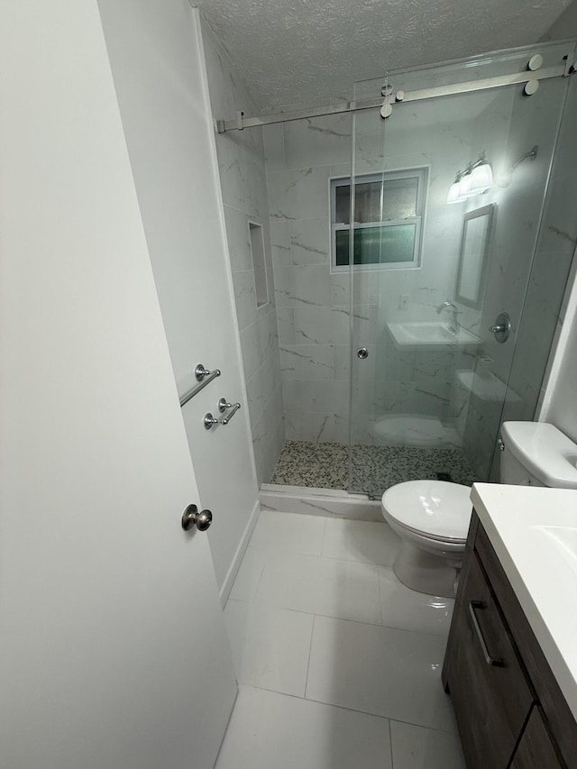 bathroom with a textured ceiling, tile patterned flooring, vanity, toilet, and a shower with shower door