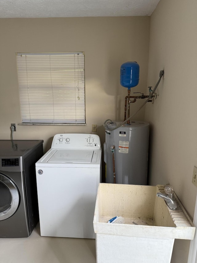 laundry area featuring washer and dryer, sink, and water heater