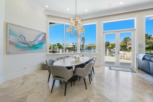 dining area with crown molding, french doors, and an inviting chandelier