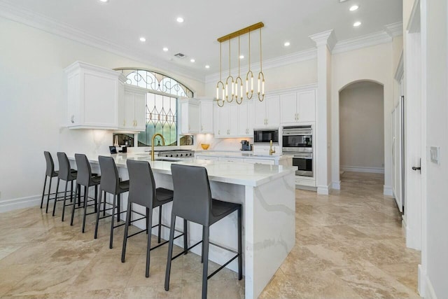 kitchen with decorative light fixtures, backsplash, black microwave, and white cabinetry