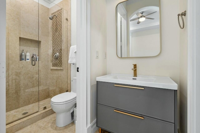 bathroom with ceiling fan, toilet, vanity, and a shower with door